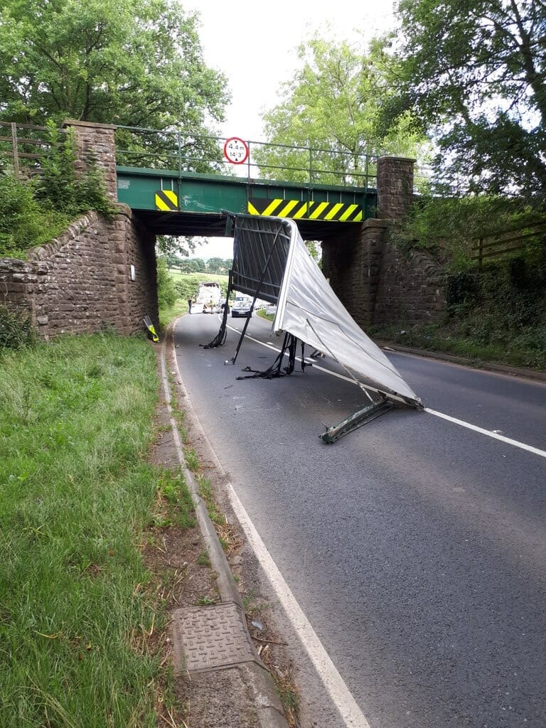 Road closed after lorry hits bridge