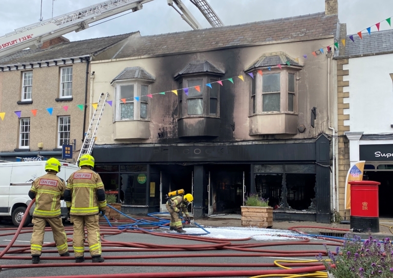NEWS | Fire crews remain on the scene after Peacocks store in Monmouth was destroyed by fire