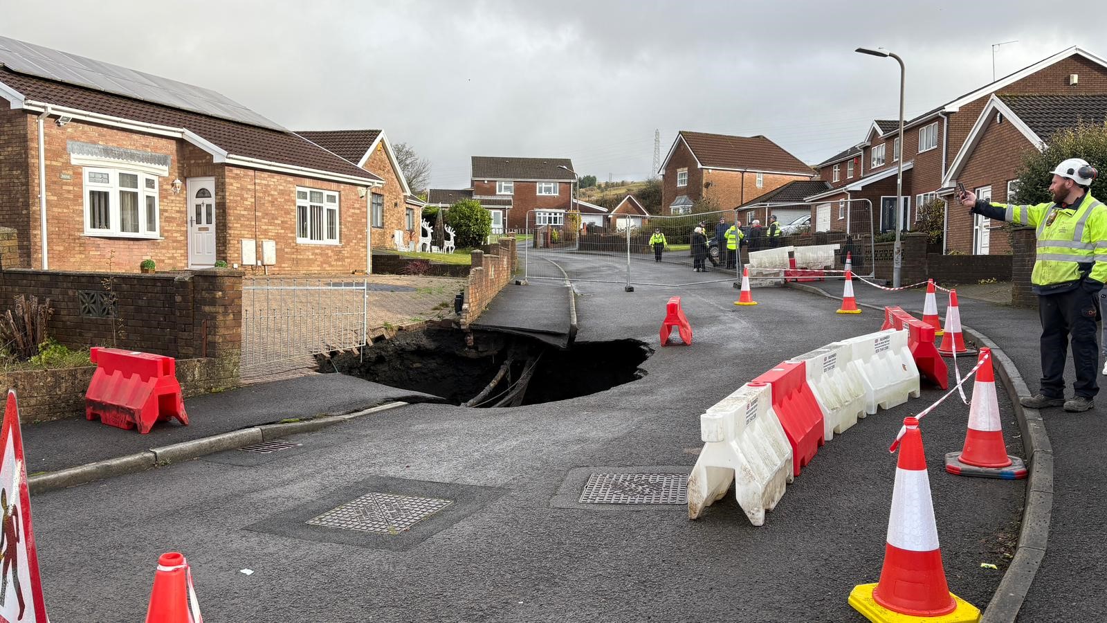 NEWS | Residents left stunned after a huge sinkhole opened up on a residential street just yards from family homes 