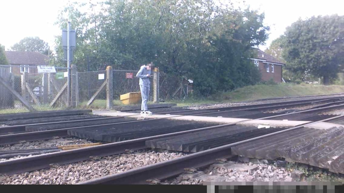 NEWS | CCTV footage shows just how close a couple pushing a pram were to being hit by a train at a level crossing