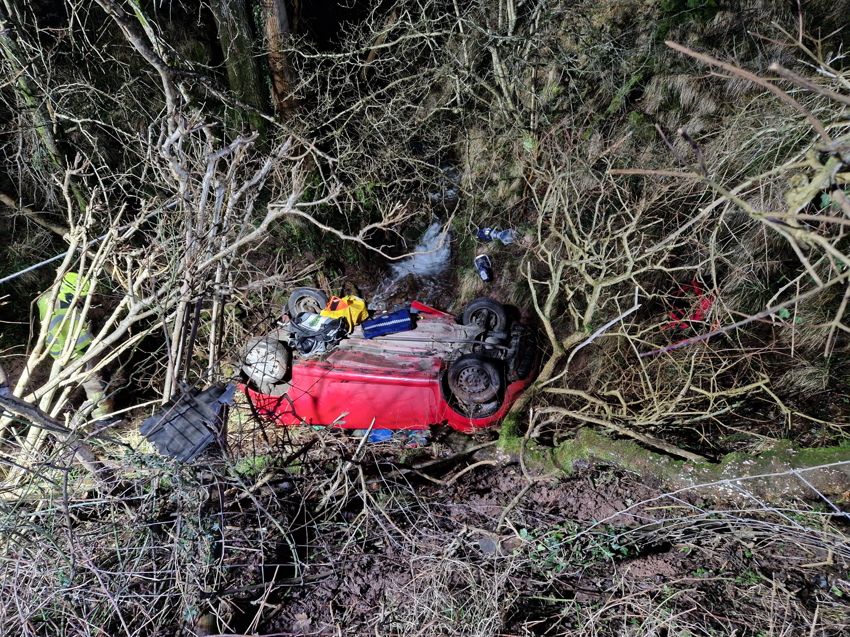 NEWS | Emergency services called after a vehicle rolled down an embankment and ended up on its roof in a stream